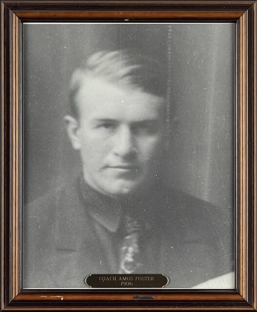 Black-and-white portrait of Amos Foster in a dark jacket.