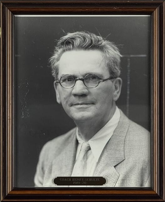 Black-and-white portrait of Henry Schulte in round spectacles and a pale jacket.