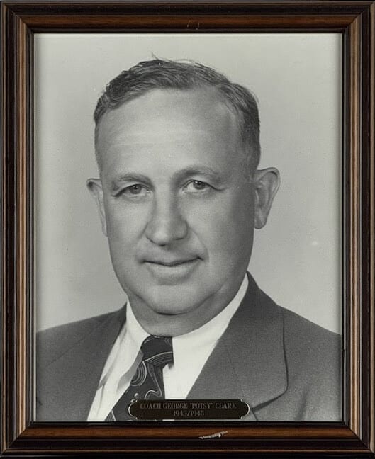 Black-and-white portrait of George Clark in a suit and tie.