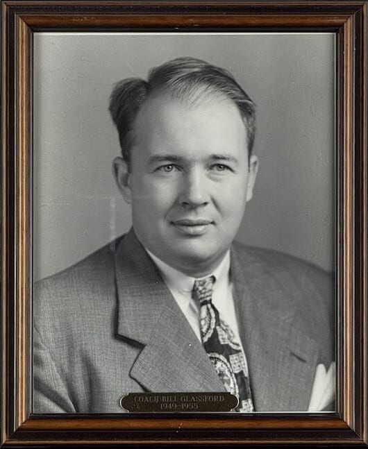 Black-and-white portrait of Bill Glassford in a tweed jacket and patterned tie.