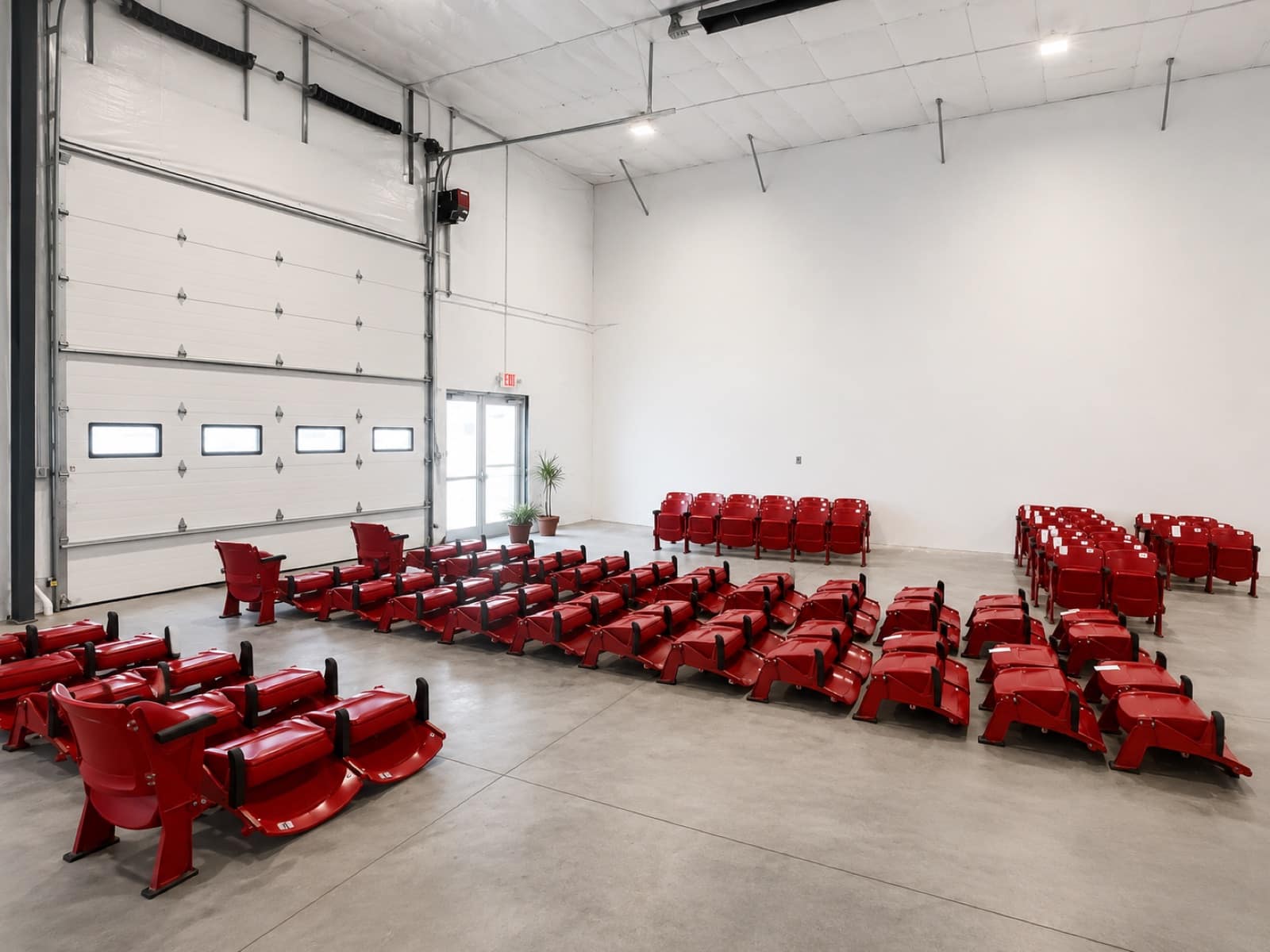 Rows of removed stadium seats stacked and inventoried in the Rare Goods warehouse